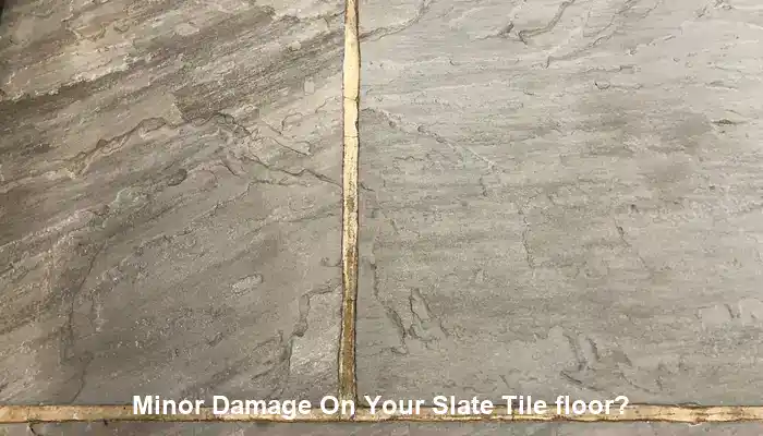Localised slate floor damage beside stable surrounding tiles needing repair assessment