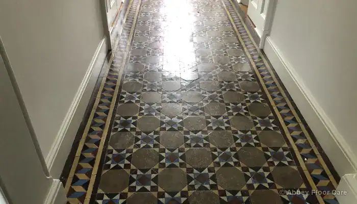 Victorian clay tile floor with a high-gloss sealer creating a reflective surface finish