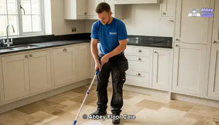 Worn travertine floor with dull patches before DIY restoration