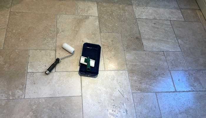 Dirty travertine floor with darkened grout and worn traffic areas before restoration