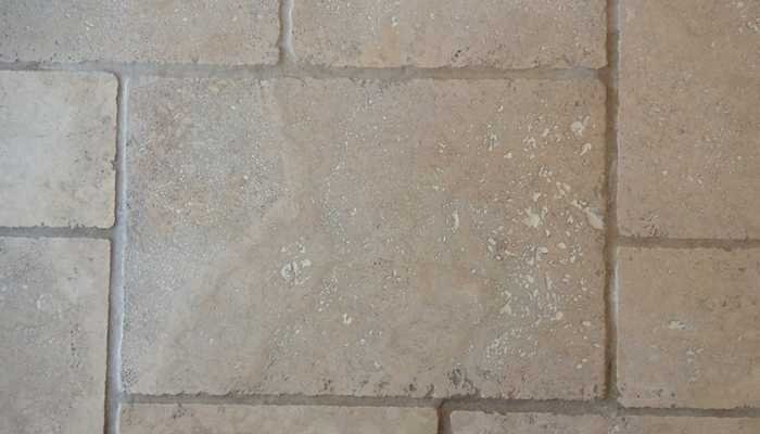 Travertine floor after professional restoration with repaired joints and an even finish