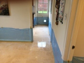 Limestone floor part-way through refinement, showing an evenly dulled surface before the final sheen was restored