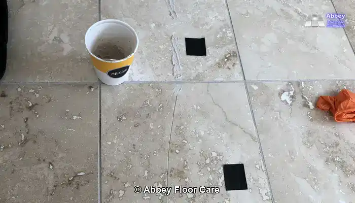 Travertine floor being restored with a rotary floor machine