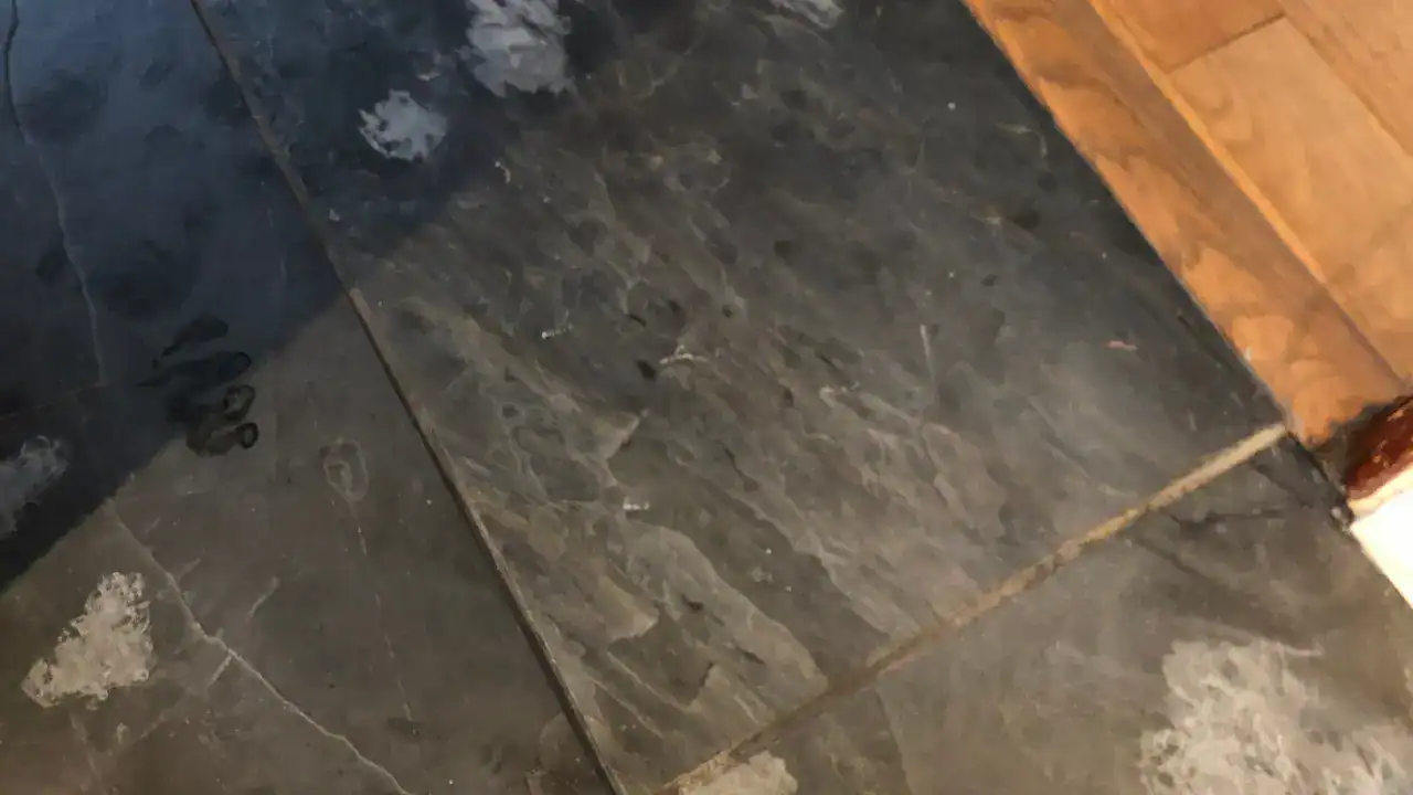 Slate floor with loose flaking areas removed before cleaning and sealing
