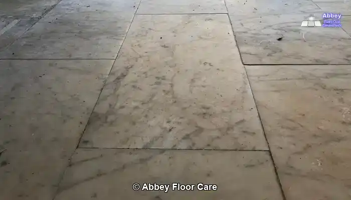Marble floor with deep discolouration before restoration