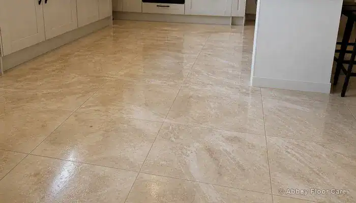 Light porcelain tiles with cloudy streaks from cleaning residue