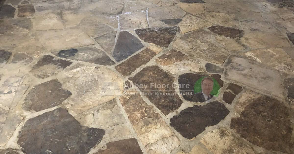 Deep cleaning in progress on an indoor riven sandstone floor to release ingrained grease and soil