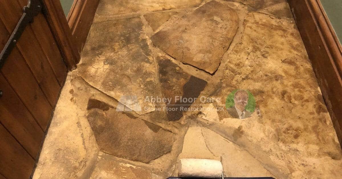 Close-up of softened, degraded mortar between sandstone flags revealed during deep cleaning
