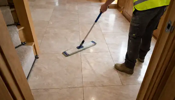 Technician applying impregnating sealer to freshly honed marble floor