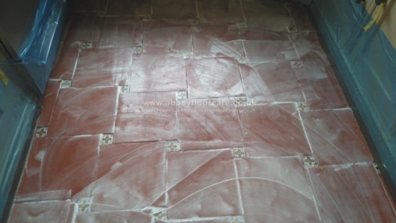 Terracotta floor being scrubbed during sealer and wax removal in Brighton
