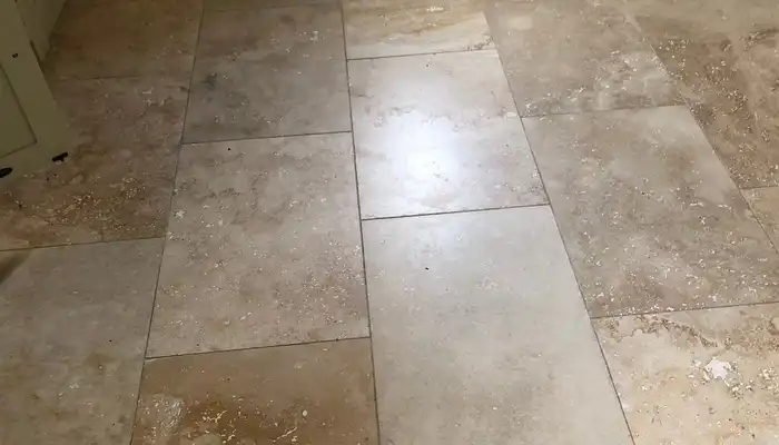 Close-up of travertine floor pits, open holes and filler repairs